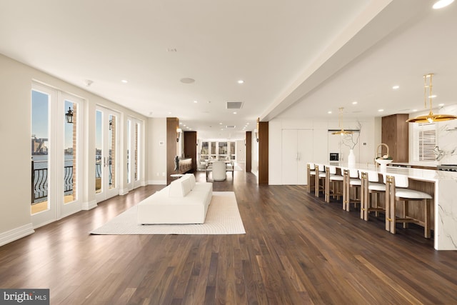 living area featuring recessed lighting, dark wood-style flooring, and french doors