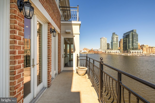 balcony featuring a view of city and a water view