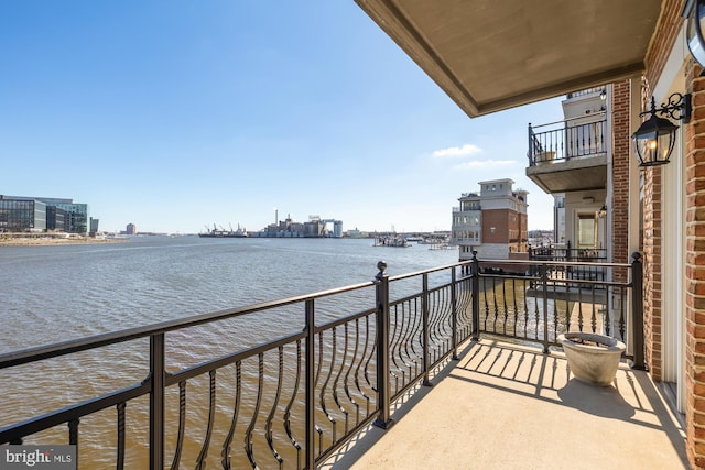 balcony featuring a view of city and a water view