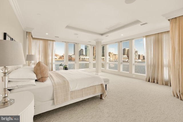 carpeted bedroom with visible vents, a raised ceiling, ornamental molding, a view of city, and recessed lighting