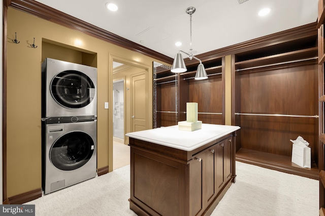 laundry area with stacked washer and clothes dryer, recessed lighting, light colored carpet, ornamental molding, and laundry area