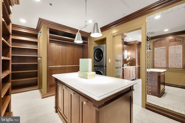 spacious closet featuring light colored carpet and stacked washer / drying machine