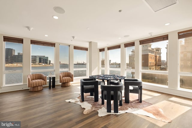 sunroom / solarium with a view of city, visible vents, and plenty of natural light