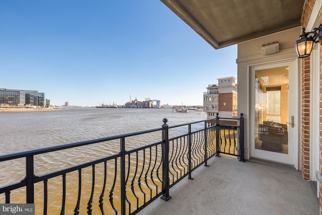 balcony with a water view and a city view