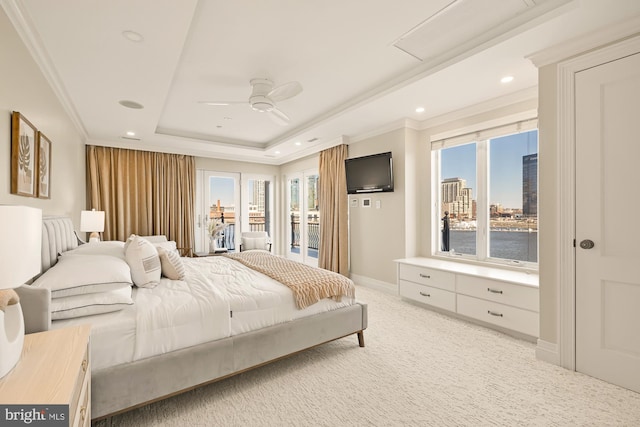 bedroom with light colored carpet, access to exterior, multiple windows, a raised ceiling, and crown molding