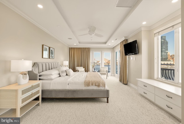 bedroom with light carpet, visible vents, ornamental molding, access to exterior, and a tray ceiling