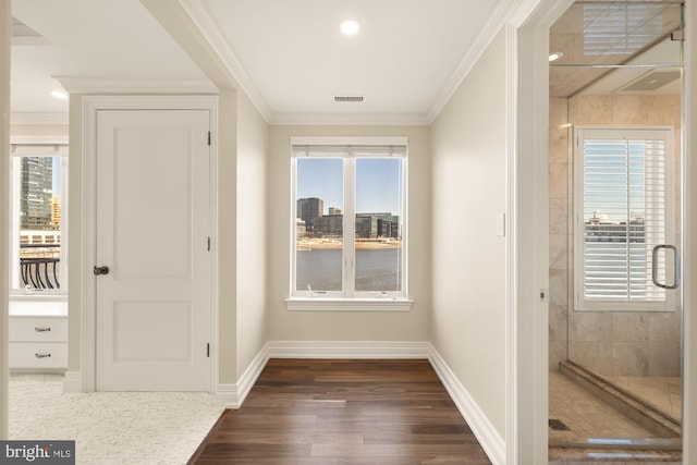 interior space featuring baseboards, dark wood-style flooring, and crown molding