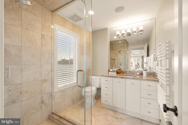 full bathroom featuring visible vents, toilet, a stall shower, a healthy amount of sunlight, and vanity