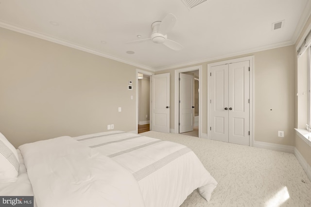 bedroom with light carpet, baseboards, visible vents, ornamental molding, and a closet