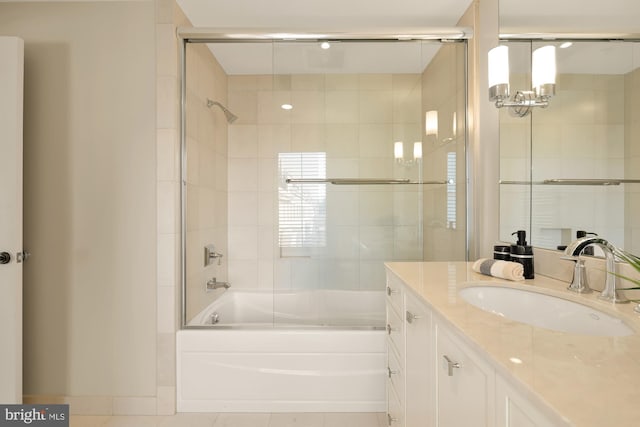 full bathroom featuring combined bath / shower with glass door, tile patterned flooring, and vanity