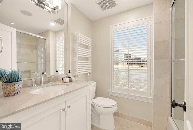 bathroom with toilet, vanity, visible vents, tile patterned floors, and radiator heating unit