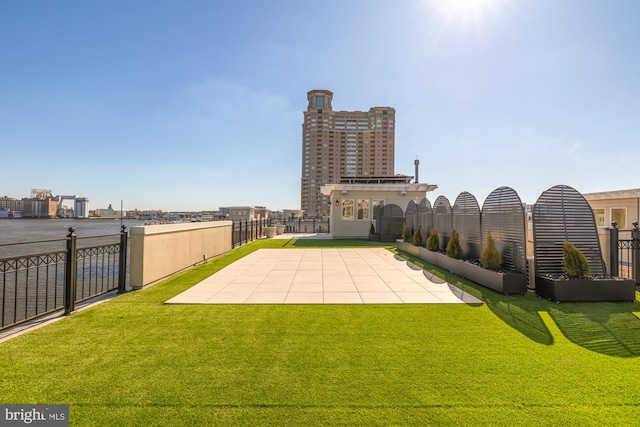 exterior space featuring a patio area, fence, and a city view