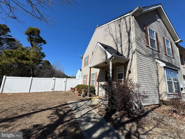 view of property exterior featuring a gate and fence