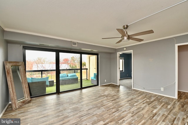 unfurnished room featuring crown molding, visible vents, light wood-style flooring, a ceiling fan, and baseboards