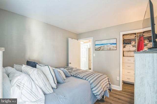 bedroom featuring dark wood-style floors and baseboards