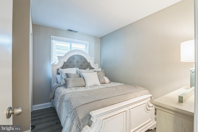 bedroom with baseboards, visible vents, and dark wood-style flooring