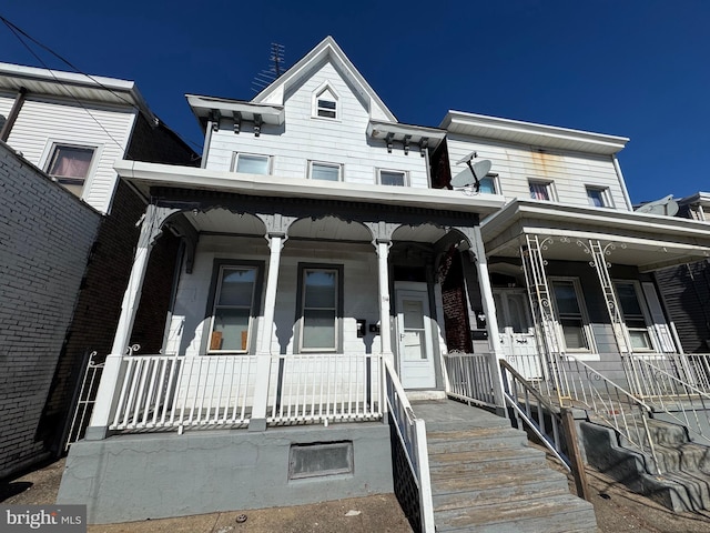 townhome / multi-family property featuring covered porch