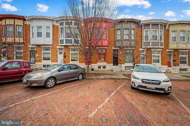 view of property featuring uncovered parking