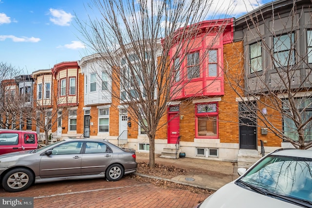 townhome / multi-family property with brick siding