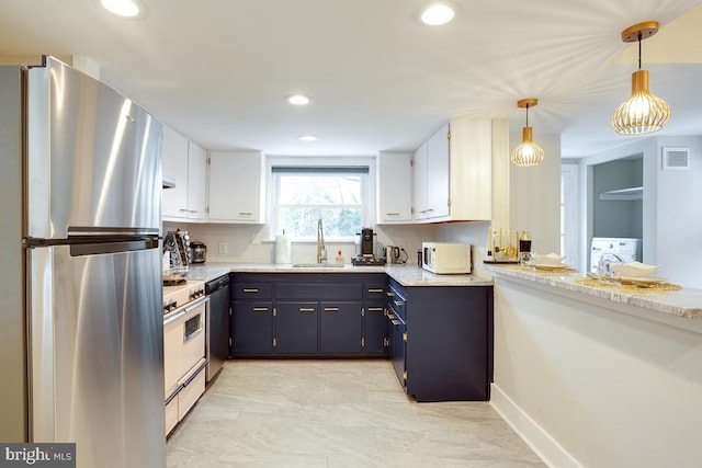 kitchen with blue cabinetry, visible vents, a sink, washer / dryer, and white appliances