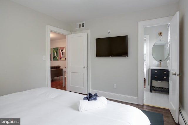 bedroom featuring baseboards, visible vents, and dark wood-type flooring