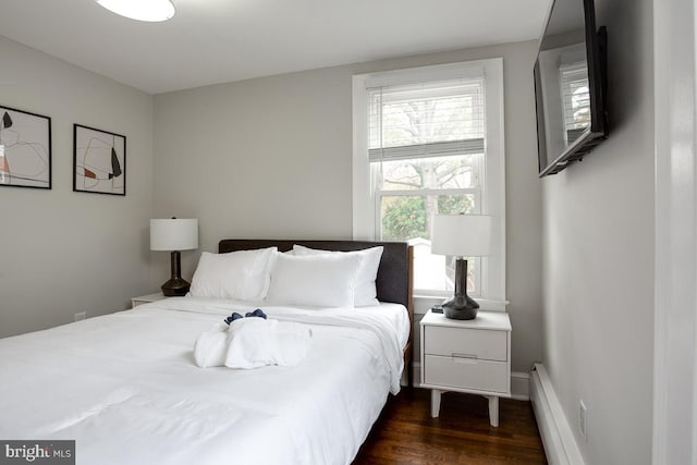 bedroom featuring dark wood-style floors and baseboard heating