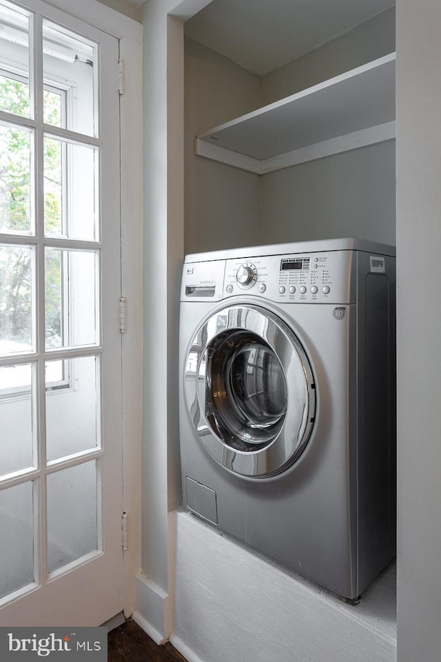 clothes washing area featuring laundry area and washer / clothes dryer