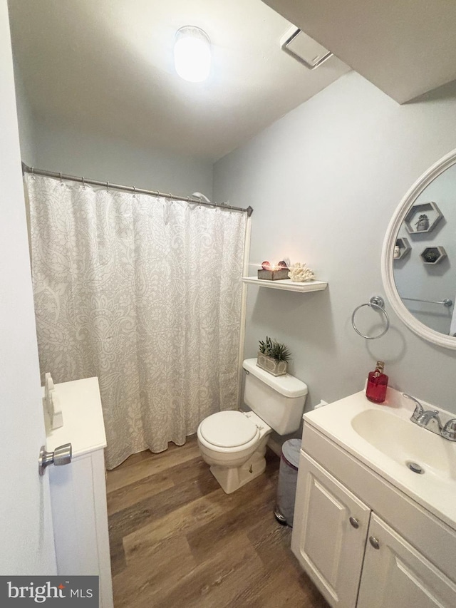 full bathroom with vanity, toilet, and wood finished floors