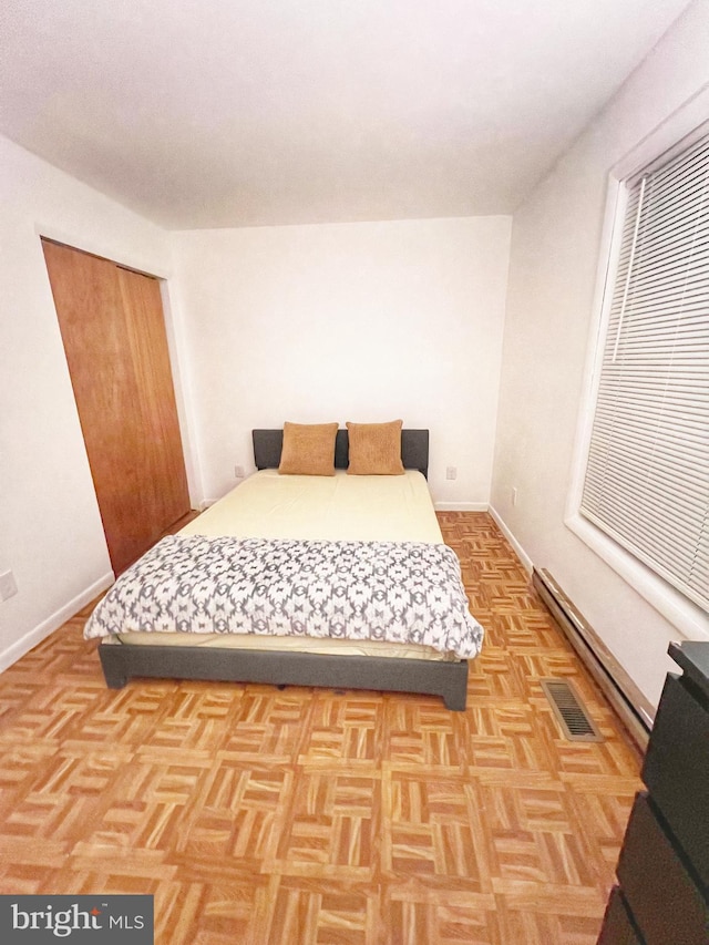 bedroom featuring visible vents and baseboards