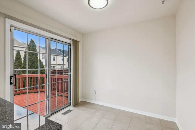 spare room featuring visible vents, baseboards, and light tile patterned floors