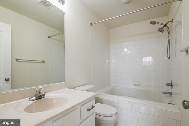 bathroom featuring toilet, visible vents, shower / washtub combination, and vanity