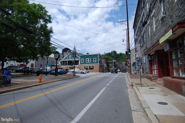 view of street with curbs, street lighting, and sidewalks