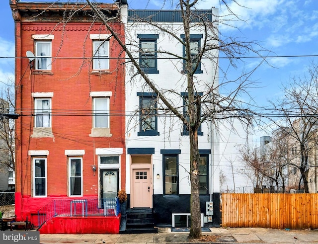 view of property with a fenced front yard and brick siding