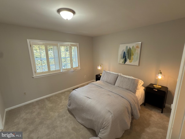 bedroom with carpet flooring and baseboards