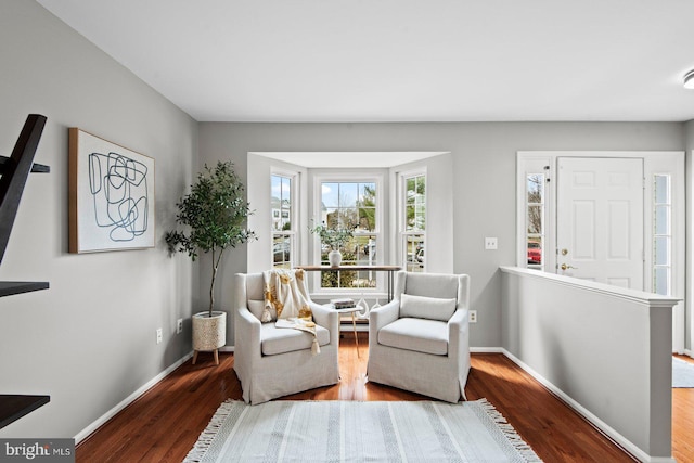 sitting room with wood finished floors and baseboards