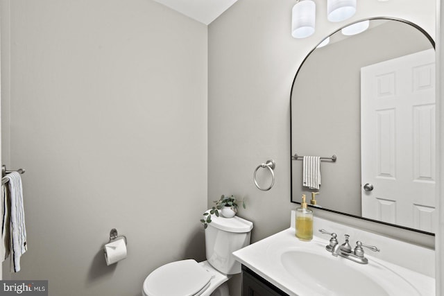 bathroom featuring toilet and vanity