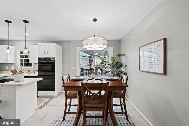 dining room with light tile patterned floors, recessed lighting, and baseboards