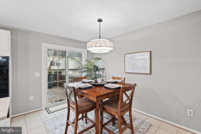 dining room featuring light tile patterned flooring and baseboards