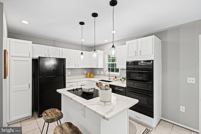 kitchen with black appliances, a sink, a kitchen island, white cabinetry, and decorative backsplash