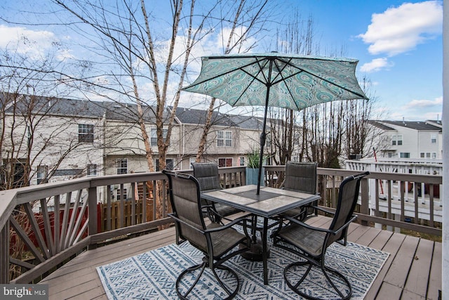 wooden deck featuring outdoor dining area