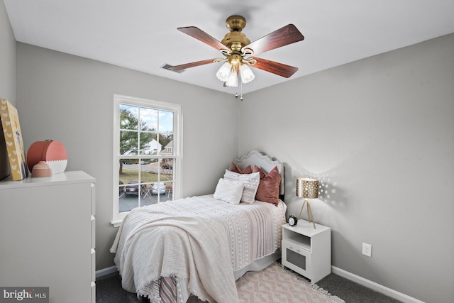 bedroom featuring visible vents, baseboards, light colored carpet, and ceiling fan