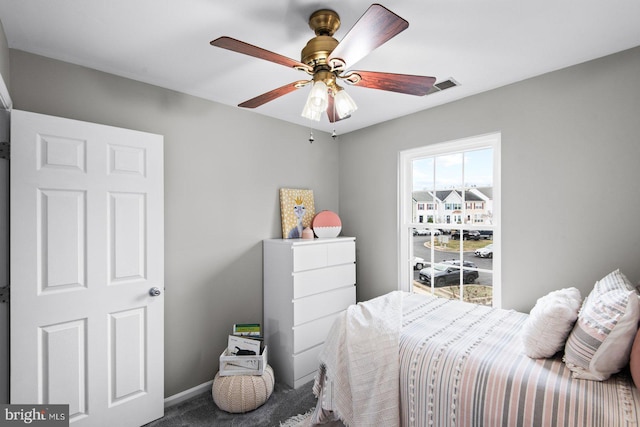 carpeted bedroom featuring visible vents, ceiling fan, and baseboards