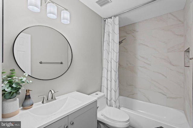 bathroom with visible vents, toilet, vanity, and shower / tub combo