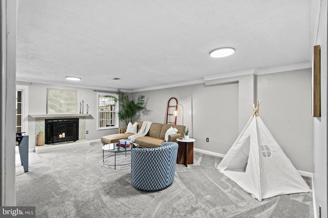 living room with a fireplace with raised hearth, carpet, and ornamental molding