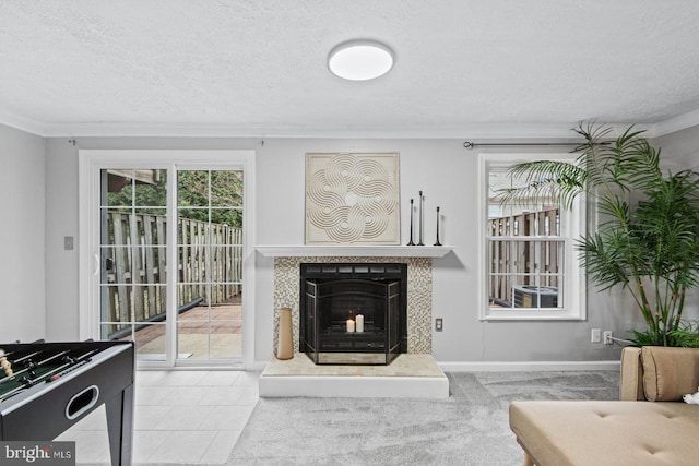 tiled living room featuring a tiled fireplace, a textured ceiling, and ornamental molding