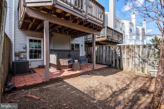 view of patio with central AC unit and fence