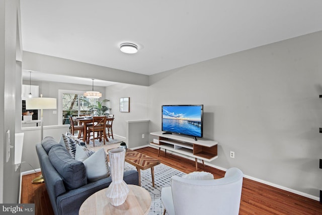 living area with wood finished floors and baseboards