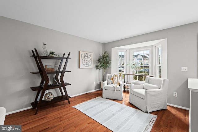 sitting room with wood finished floors and baseboards