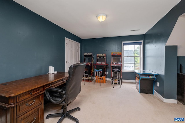 home office with light colored carpet, visible vents, and baseboards