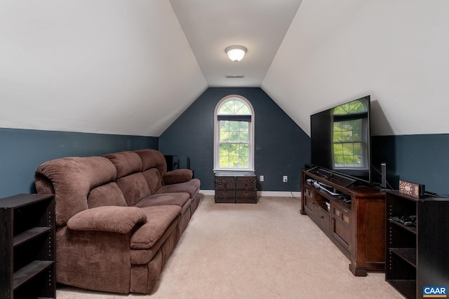 living area featuring light carpet, baseboards, visible vents, and vaulted ceiling